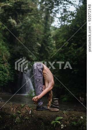 Yoga practice and meditation in nature. Man practicing near river 92071548