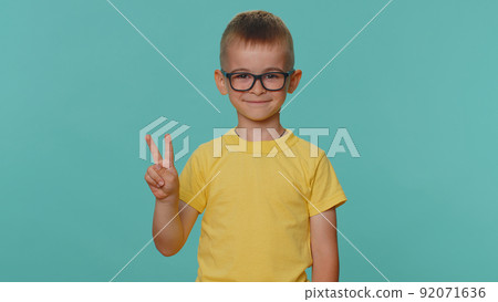 Happy smiling toddler children boy showing victory sign, hoping for success win, doing peace gesture 92071636