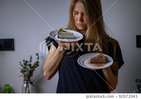 Girl holds a plates of vegan cakes. Cashewcakes Girl holds a plates of vegan cakes. Cashewcakes 92072043