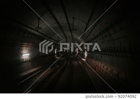 Front cabin view of driverless metro train moving through underground tunnel. Automated advanced Front cabin view of driverless metro train moving through underground tunnel. Automated advanced 92074092