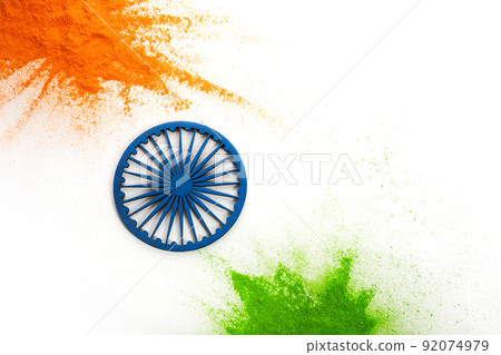 Orange and green color powder splash with Ashoka wheel. Concept for India independence day, 15th of august. Orange and green color powder splash with Ashoka wheel. Concept for India independence day, 15th of august. 92074979