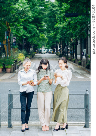 Women of all ages using smartphones 92076104