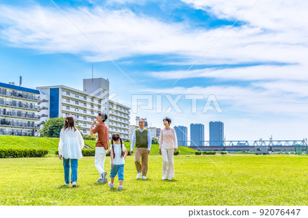 A close family and an elderly couple walking along the riverbed. Three generations of the family A close family and an elderly couple walking along the riverbed. Three generations of the family 92076447