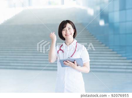 Young nurse walking in the lobby Young nurse walking in the lobby 92076955