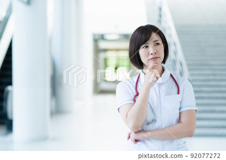 Worried young female nurse Worried young female nurse 92077272