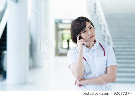 Worried young female nurse Worried young female nurse 92077274