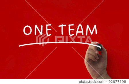 One team text on red cover background. Teamwork concept One team text on red cover background. Teamwork concept 92077396