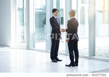 Businessman shaking hands 92077592