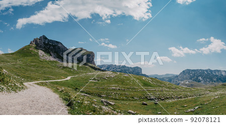 Amaizing view on Durmitor mountains, National Park, Mediterranean, Montenegro, Balkans, Europe. Bright summer view from Sedlo pass. The road near the house in the mountains. 92078121