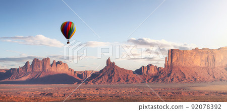 Hot Air Balloon flying over Desert Rocky Mountain American Landscape. 92078392