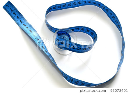 A rag meter of a seamstress lies on a white background. 92078401
