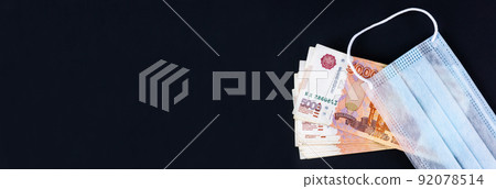 Money and medical mask on a black background. 92078514