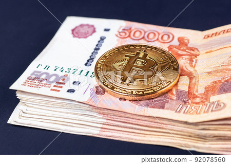 Bitcoin coins on Russian banknotes 92078560