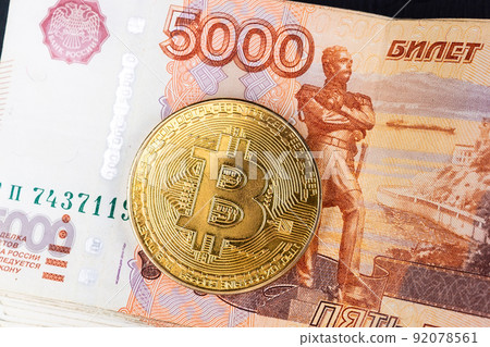 Bitcoin coins on Russian banknotes 92078561