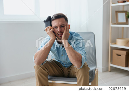 Upset frustrated young tanned wasted mission with joystick gamepad reclines on hand at home. Stream Platform for gamers concept. Relaxing Active recreation. Copy space for game console advertising Upset frustrated young tanned wasted mission with joystick gamepad reclines on hand at home. Stream Platform for gamers concept. Relaxing Active recreation. Copy space for game console advertising 92078639