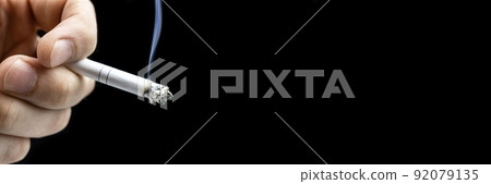Cigarette hand black background Cigarette hand black background 92079135