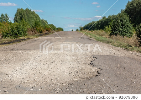Broken asphalt road Broken asphalt road 92079390