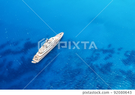 Multideck yacht in a bay with azure water. Summer holidays and trips on the ship. 92080643