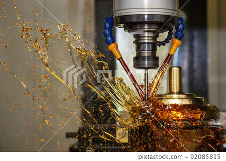 The splash of oil coolant on CNC milling machine. The splash of oil coolant on CNC milling machine. 92085815