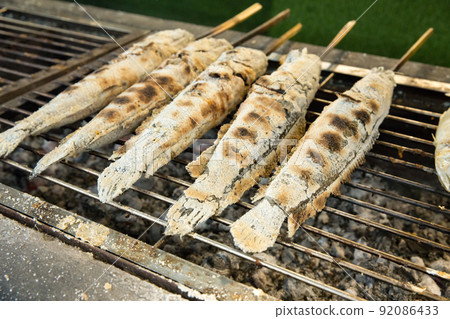 Top view of grilled snake-head fish on the stainless colander, focus selective 92086433