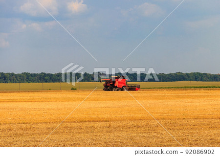 Combine harvester working on a wheat field. Harvesting the wheat. Agriculture concept 92086902