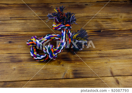 Colorful rope toy for dog on wooden background Colorful rope toy for dog on wooden background 92087793