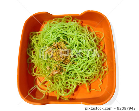 Jade noodles with fried garlic in dish, Green handmade noodles, Isolated on white background Jade noodles with fried garlic in dish, Green handmade noodles, Isolated on white background 92087942