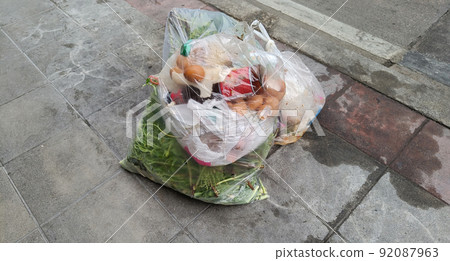 Plastic food waste trash bags on pavement street. Smelly rotten,unhealthy for the respiratory tract. Plastic food waste trash bags on pavement street. Smelly rotten,unhealthy for the respiratory tract. 92087963