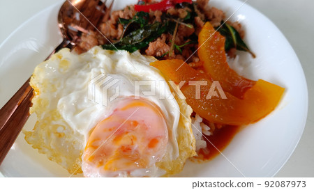 Thai food fried egg served with rice and stir-fried pork spicy and basil Thai food fried egg served with rice and stir-fried pork spicy and basil 92087973
