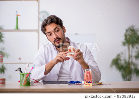 Young male dentist working in the clinic Young male dentist working in the clinic 92088912