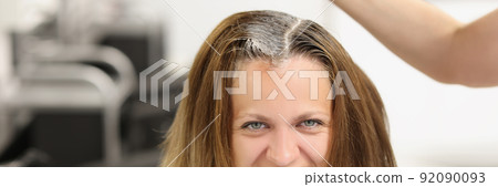 Happy client sit at hairdresser, master apply dye colour on hair with brush equipment Happy client sit at hairdresser, master apply dye colour on hair with brush equipment 92090093