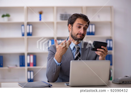 Young male employee holding wallet Young male employee holding wallet 92090432
