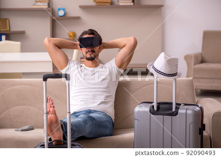 Young man preparing for trip at home Young man preparing for trip at home 92090493