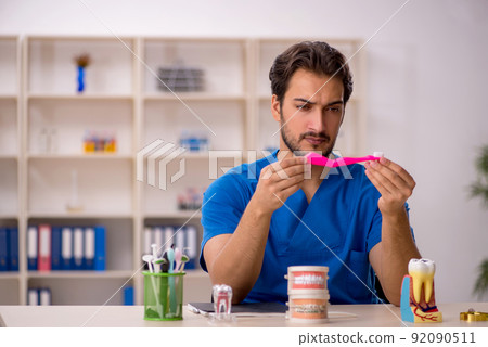 Young male dentist working in the clinic Young male dentist working in the clinic 92090511