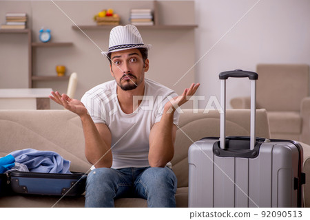 Young man preparing for trip at home Young man preparing for trip at home 92090513