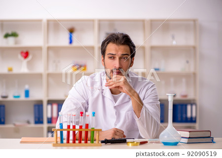 Young male chemist working at the lab 92090519