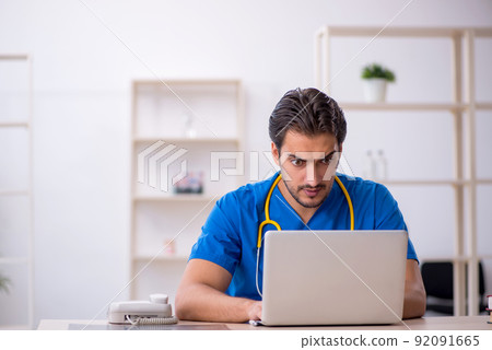 Young male doctor in telemedicine concept Young male doctor in telemedicine concept 92091665