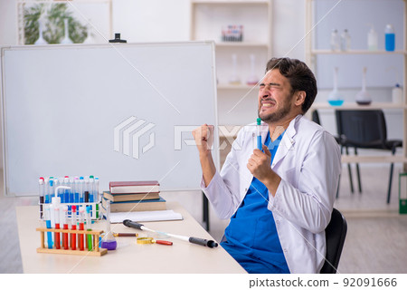 Young male chemist working at the lab 92091666