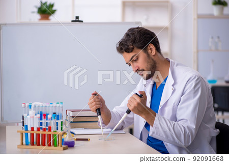 Young male chemist working at the lab Young male chemist working at the lab 92091668