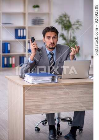 Young male employee working in the office 92092288