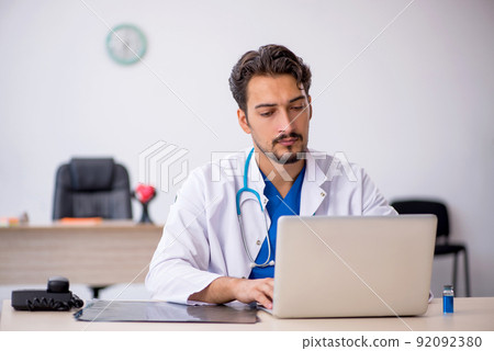 Young male doctor working in the clinic Young male doctor working in the clinic 92092380