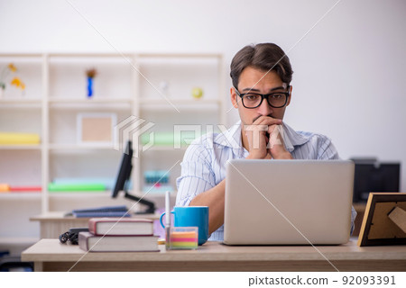 Young male employee working in the office 92093391