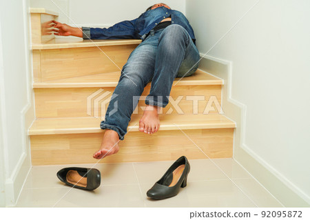 Asian business woman pain ankle, foot with leg cramp and fall down the stairs because slippery surfaces in office. 92095872