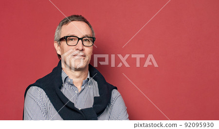 Successful confident businessman on red background portrait 92095930