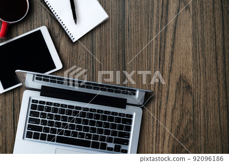 Workplace in office with wooden desk. Top view from above of equipment placed and coffee. Space for modern creative work of designer. Workplace in office with wooden desk. Top view from above of equipment placed and coffee. Space for modern creative work of designer. 92096186