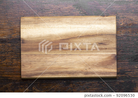 Cutting board on wood kitchen table. Food recipe concept at wood background texture with copy space. 92096530