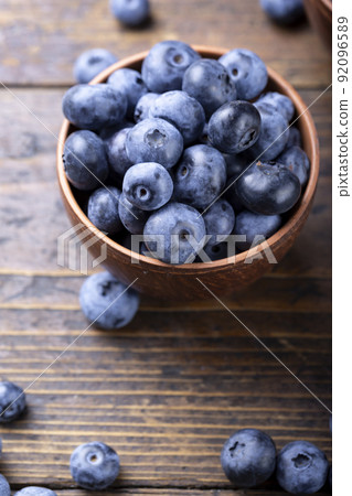 Freshly picked blueberries in  bowl. Bilberry on wooden Background.  92096589