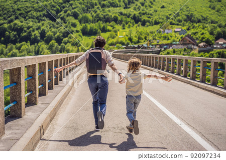 Montenegro. Father and son tourists in background of Dzhurdzhevich Bridge Over The River Tara. Travel around Montenegro concept. Sights of Montenegro 92097234