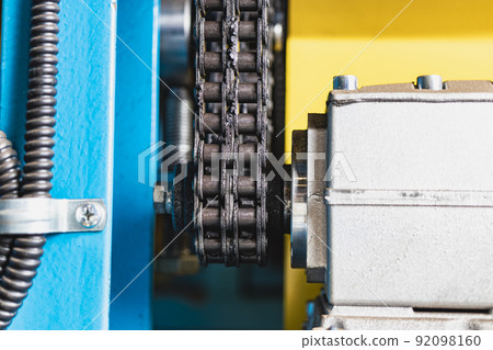 Chain transmission on an industrial machine. Elements of the machine close-up for bending sheet steel. Industrial equipment for metalworking. 92098160