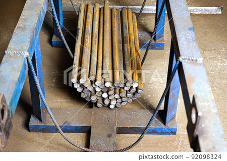Blanks of metal rods at the factory for further processing. Warehousing and storage of prepared elements for metalworking. Blanks of metal rods at the factory for further processing. Warehousing and storage of prepared elements for metalworking. 92098324